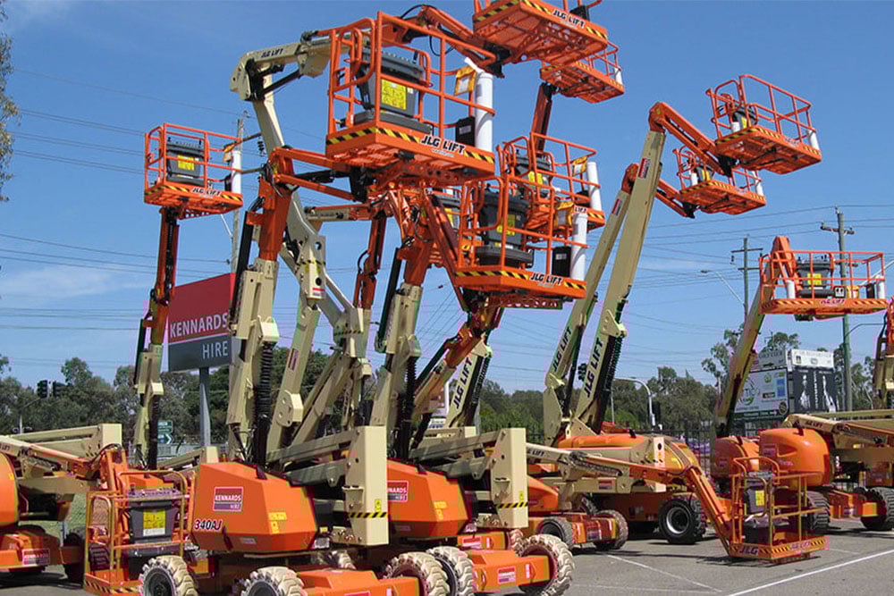 6 boom  lifts from a distance in operation