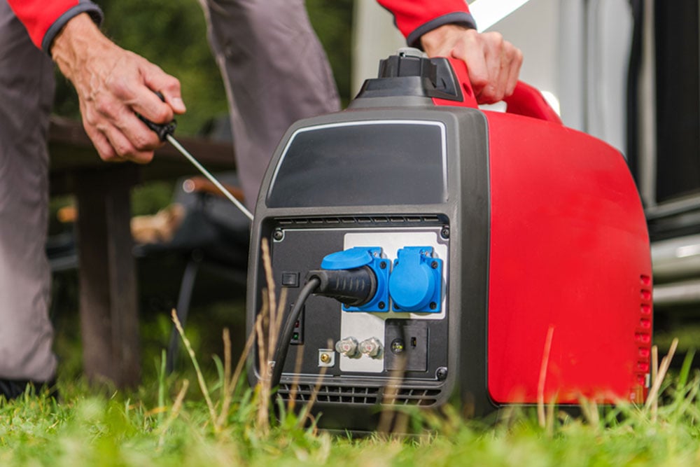 Kennards Hire team member starting a stationary generator