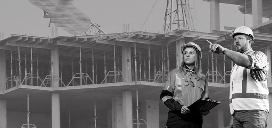 two people standing on a construction site