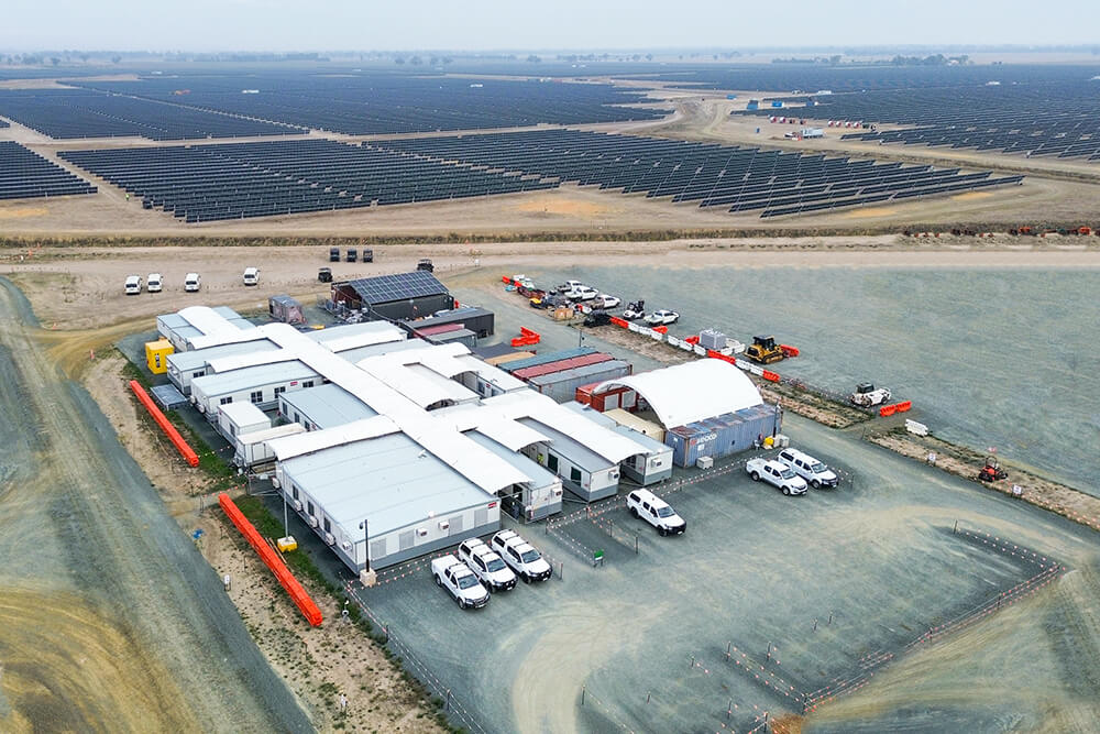 Birds eye view of the Girgarre solar project site - rows of solar panels and a plot of site buildings and cars