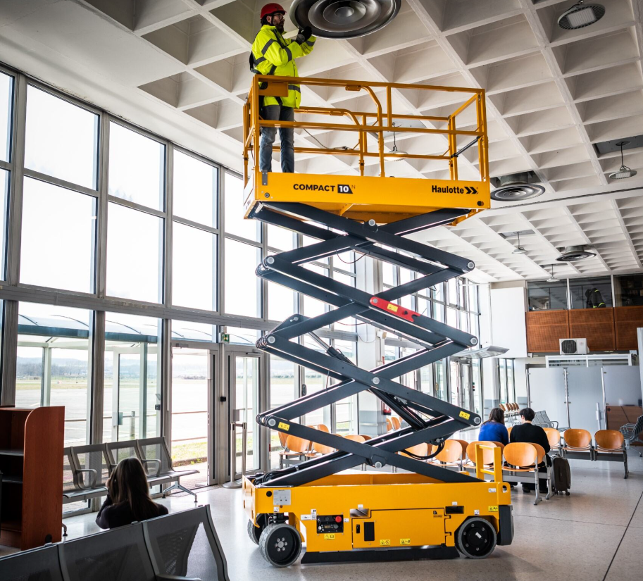 Kennards hire team member on a scissor lift being operated indoors